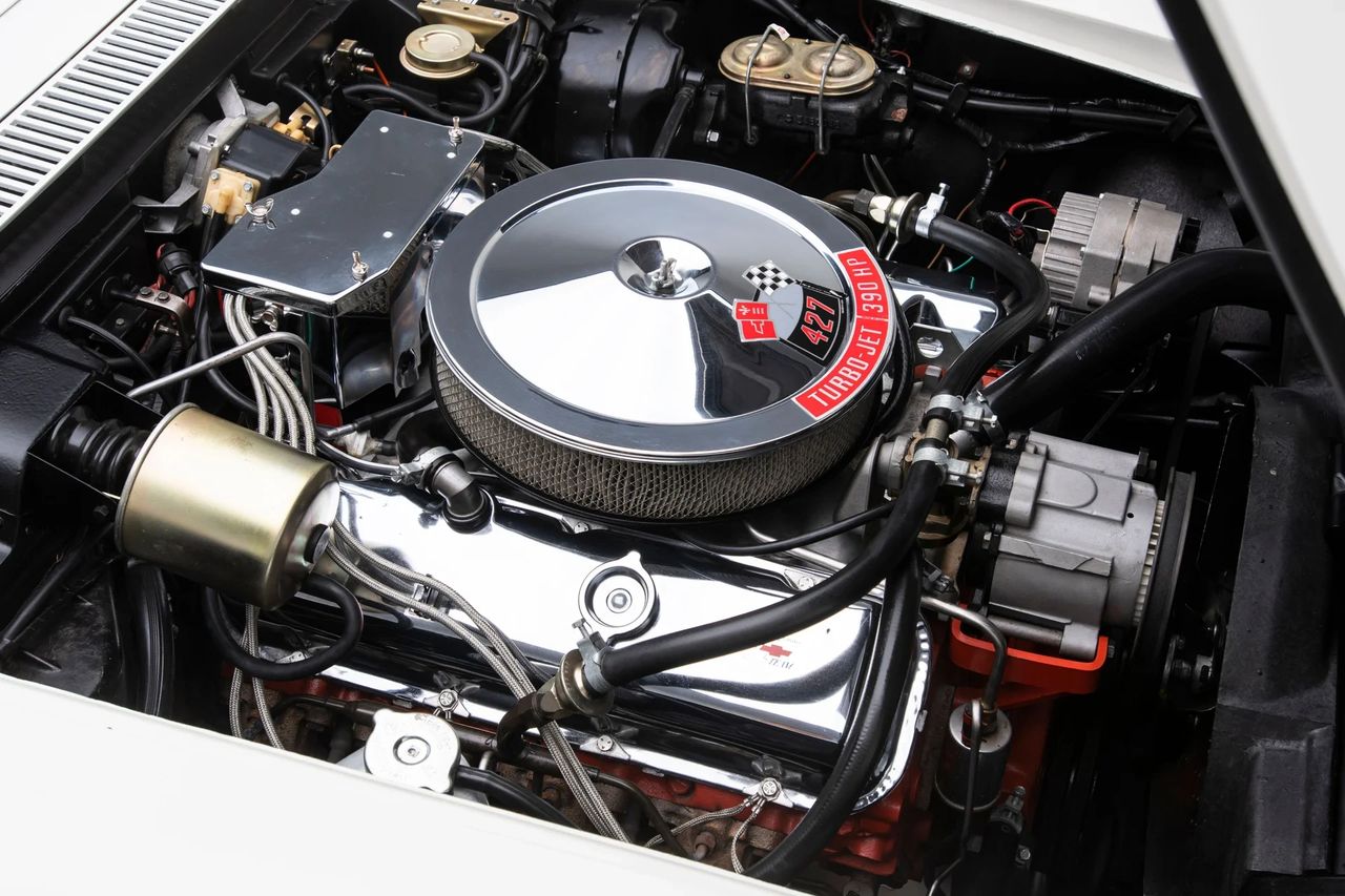 The L36 427-cubic-inch V8, shown here in factory dress, offered the best of both worlds—big-block authority with everyday manners. Rated at 390 horsepower, it used oval-port iron heads, a single four-barrel carburetor, and a hydraulic camshaft to deliver effortless torque and a smooth, broad powerband. Chrome valve covers and a polished air cleaner added visual punch under the hood, but the real appeal was its drivability: muscular, refined, and ready to perform without demanding constant tuning. For many Corvette buyers, the L36 was the sweet spot—a true muscle engine that didn’t sacrifice street comfort. (Image courtesy of RK Motors)