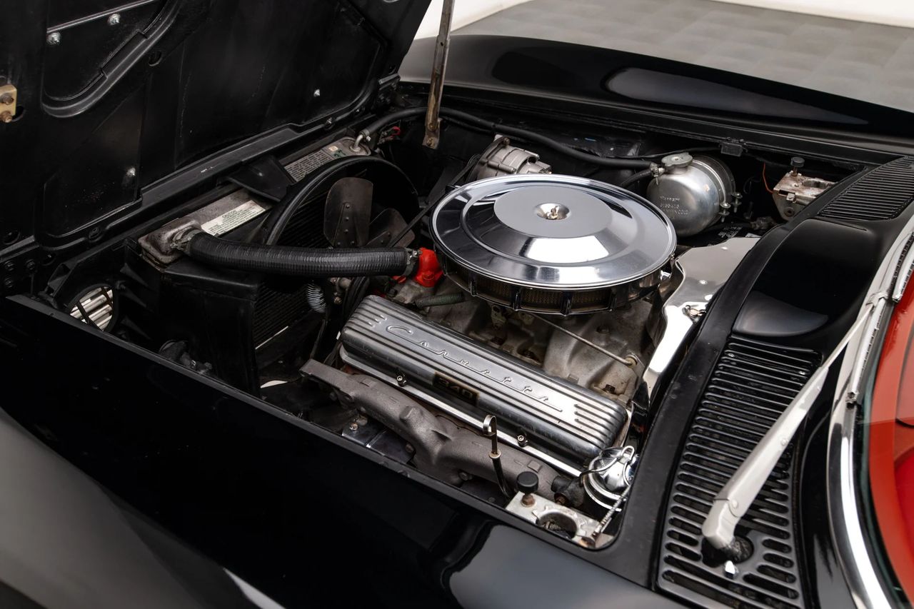Under the hood of the 1963 Corvette Sting Ray lies Chevrolet’s potent 327-cubic-inch V8, shown here topped with a chrome air cleaner and finned aluminum valve covers proudly embossed with “Corvette.” Depending on configuration, this small-block delivered between 250 and 360 horsepower, with the top-tier fuel-injected version making the Sting Ray a genuine world-class performance car. Clean, purposeful, and beautifully engineered, the 327 became the beating heart of the Corvette’s second generation. (Image courtesy of RK Motors.) Under the hood of the 1963 Corvette Sting Ray lies Chevrolet’s potent 327-cubic-inch V8, shown here topped with a chrome air cleaner and finned aluminum valve covers proudly embossed with “Corvette.” Depending on configuration, this small-block delivered between 250 and 360 horsepower, with the top-tier fuel-injected version making the Sting Ray a genuine world-class performance car. Clean, purposeful, and beautifully engineered, the 327 became the beating heart of the Corvette’s second generation. (Image courtesy of RK Motors.)