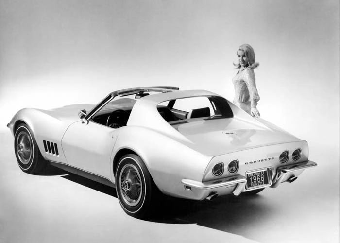 A studio-fresh 1968 Corvette coupe shows off the Shark era’s new coke-bottle curves—tucked waist, flared fenders, and those triple “gill” vents. The open roof highlights the debut of removable T-top panels (and the coupe’s removable rear window), a big step toward open-air drama without going full convertible. Wire-style covers, quad tail lamps, and clean bumperettes complete the press-kit perfection. It’s pure late-’60s glamour: cutting-edge fiberglass wrapped in show-room spotlight. (Image courtesy of GM Media LLC)