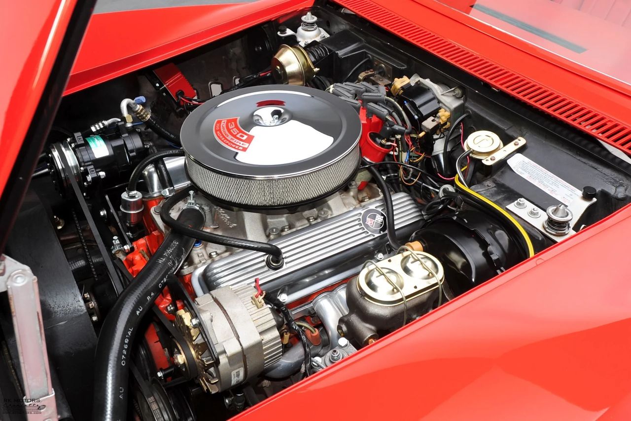 Shown here is the all-new 350-cubic-inch small-block V8 introduced for 1969—a foundational shift for the Corvette that quietly elevated performance and drivability. Replacing the long-serving 327, the 350 retained the same bore but gained stroke for a broader torque curve and smoother power delivery. Available in both 300- and 350-horsepower variants, it paired modernized internals with Corvette-specific breathing, including big-block-sized 2.5-inch exhausts that gave even base cars a richer, more muscular voice. Neatly dressed with finned aluminum valve covers and a low-profile air cleaner, the 350 blended performance and polish in a way only a Corvette could. (Image courtesy of RK Motors)