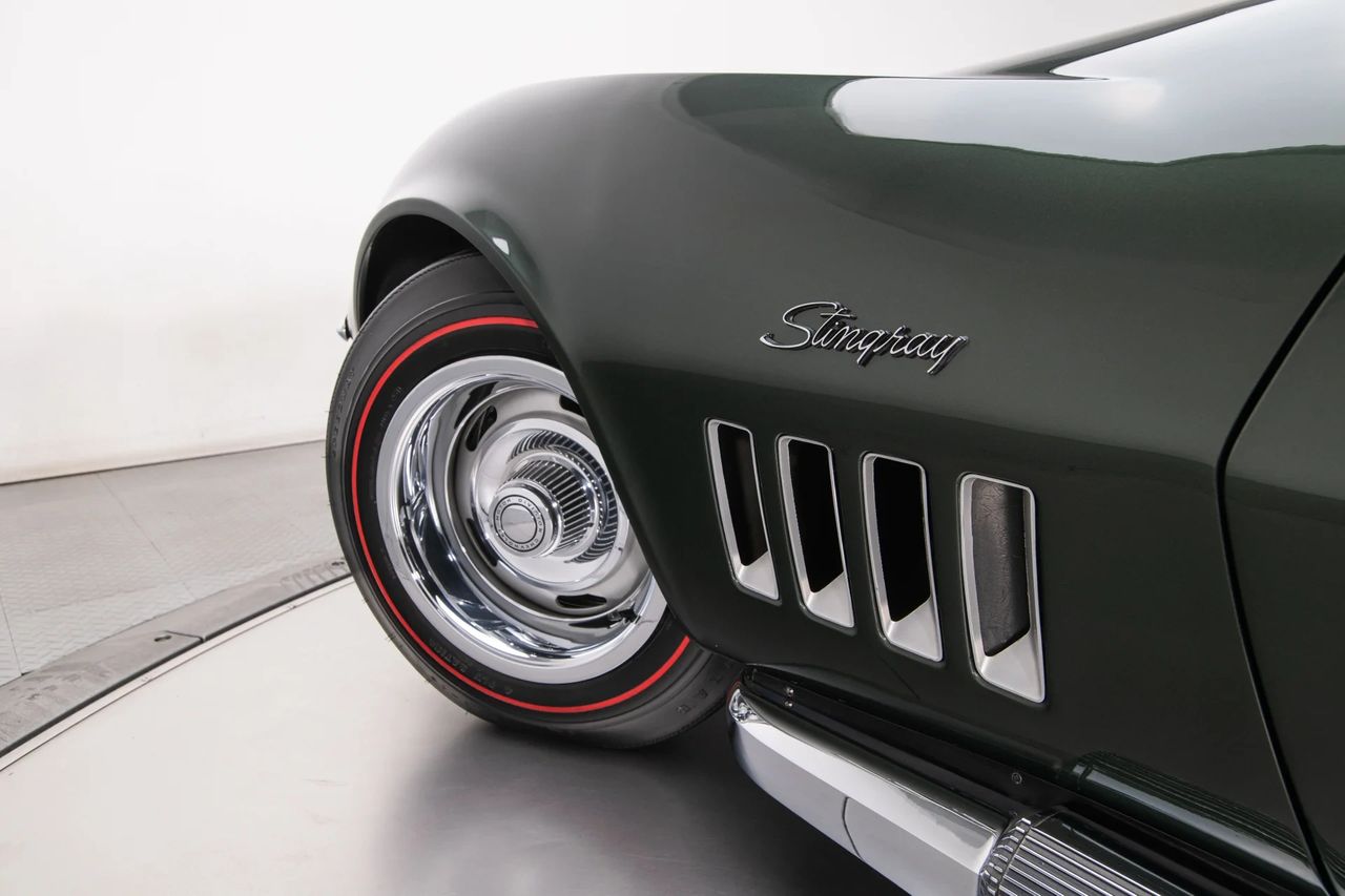 New for 1969, the thin-script “Stingray” fender emblems marked the first time the name appeared as a single word—clean, modern, and integrated into the body’s flow. It was a small but meaningful update, signaling the Corvette’s evolution into a more cohesive, performance-focused identity. Paired with the optional N14 side-mounted exhaust, the look became unmistakably aggressive: bright polished covers running the length of the rocker panels, visually lowering the car and giving voice to its big-displacement intent. Together, the script and the side pipes weren’t just styling elements—they were statements. (Image courtesy of RK Motors)