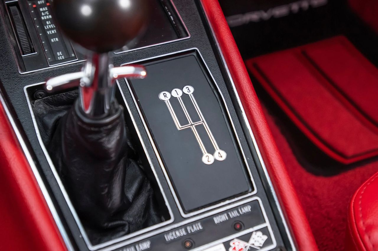 The ’69 Corvette stuck with the aluminum-case Muncie four-speeds, offered in two flavors: the wide-ratio M20 and the close-ratio M21. The M20 (2.52:1 first, 1.88:1 second, 1.46:1 third, 1.00:1 fourth) was the street-friendly choice—strong launches with taller axle gears (3.36–3.55), easy drivability, and a broader split between gears that suited the new 350-cid small-blocks and most big-block street combos. The M21 (2.20:1 first, 1.64:1 second, 1.28:1 third, 1.00:1 fourth) tightened the steps for engines that liked to rev, typically paired with deeper rear gears (3.70–4.11) and the high-output 427s; keep the motor in the power band and it feels razor-sharp. Both boxes used the familiar 10-spline input/27-spline output shafts in ’69, robust brass synchros, and a positive, chrome stick with a reverse lockout gate—by this year most cars benefited from cleaner Hurst-style linkage and a firmer, less rubbery shift feel. Clutch hardware scaled with power—10.5-inch for most small-blocks, 11-inch for heavy-duty big-block applications—and either transmission was happy behind serious torque if you respected the clutch. (A handful of heavy-duty M22 “Rock Crusher” units slipped into the 427 crowd, recognizable by their straighter-cut gears and trademark whine, but the core 4-speed story in 1969 is the M20 for breadth and the M21 for bite.) (Image courtesy of RK Motors)