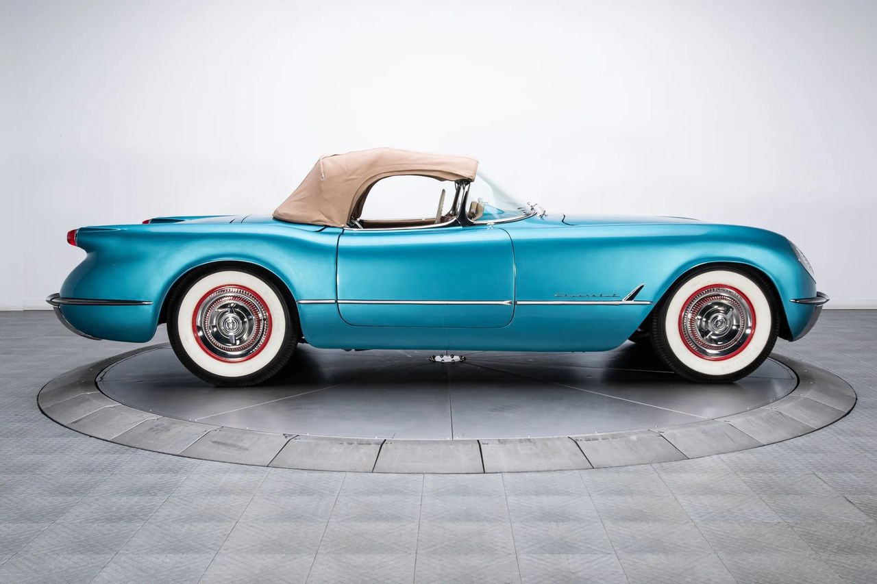 For 1954, Chevrolet made an important refinement to the Corvette’s appearance and comfort by introducing canvas convertible tops in tan and beige. The change replaced the black fabric used on the inaugural 1953 cars, giving the Corvette a lighter, more European-inspired look that paired beautifully with colors like the Pennant Blue example shown here. This subtle update was part of a wave of thoughtful improvements in 1954 that helped transform the Corvette from a show-car curiosity into a more sophisticated and appealing production sports car. (Image courtesy of RK Motors)