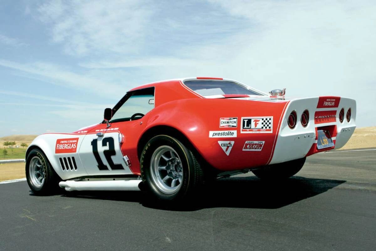 Owens-Corning Fiberglas turned the new C3 into a statement with this #12 L88-powered coupe—wide flares to swallow racing slicks, side pipes, quick-fill fuel, big brakes, and the mandated roll cage under the shark skin. Built around Chevrolet’s competition-minded 427 L88 (high compression, solid lifters, aluminum heads, cold-air induction), the car made well north of its “430-hp” rating on race fuel and proved the C3 body could live at speed. Driven by Tony DeLorenzo and Jerry Thompson, the Owens-Corning team made the L88 package the class benchmark in SCCA A-Production, stringing together a dominating run of wins and securing back-to-back national titles as the program hit its stride. They also showed the platform’s endurance chops with podium-level results and class victories in long-distance events, turning privateer Corvettes into credible threats beyond sprint races. In effect, this car—and the L88 with it—moved Corvette from “wild new shape” to “front-running tool,” proving the C3’s aerodynamics, cooling, and chassis could carry big power and bigger expectations.