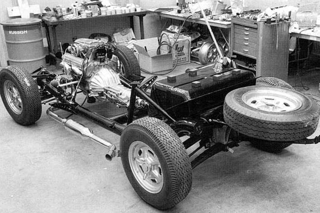 The 1963 Corvette Grand Sport chassis was based on the production Sting Ray’s 98-inch wheelbase frame, but it was extensively reengineered for competition under the direction of Zora Arkus-Duntov. The frame rails were fabricated from thinner-gauge steel to reduce weight, while aluminum was used extensively for suspension components, brake backing plates, and other hardware. Independent rear suspension was retained, but reinforced to handle wider wheels, racing tires, and significantly higher cornering loads. Combined with a large-capacity fuel tank and side-exit exhaust, the chassis reflected Duntov’s intent to create a true lightweight GT racer that remained structurally recognizable as a Corvette.