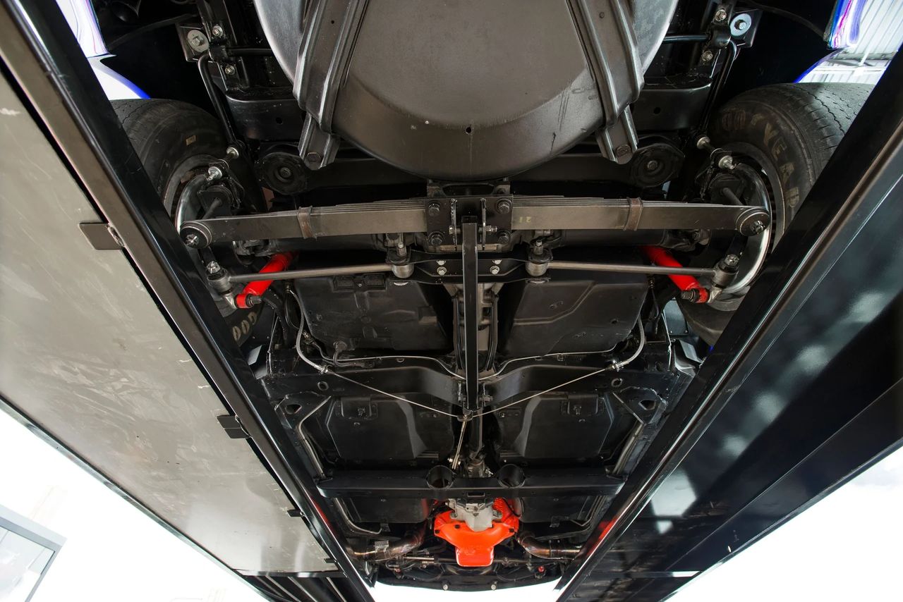 The 1969 Corvette retained its rugged independent rear suspension, anchored by a differential housed in a carrier with a transverse leaf spring and trailing arms, giving the car both strength and ride compliance. Buyers could choose from a wide range of axle ratios, starting as mild as 3.08:1 for relaxed highway cruising, and running all the way up to 4.56:1 for drag strip duty, with 3.36:1, 3.55:1, and 3.70:1 serving as popular middle grounds. Positraction was still optional but strongly recommended, especially with the high-torque big-block engines, ensuring better traction under hard acceleration. This variety of rear-end setups meant the Corvette could be tailored for long-distance touring, balanced performance driving, or all-out straight-line acceleration depending on the buyer’s taste. (Image courtesy of RK Motors)