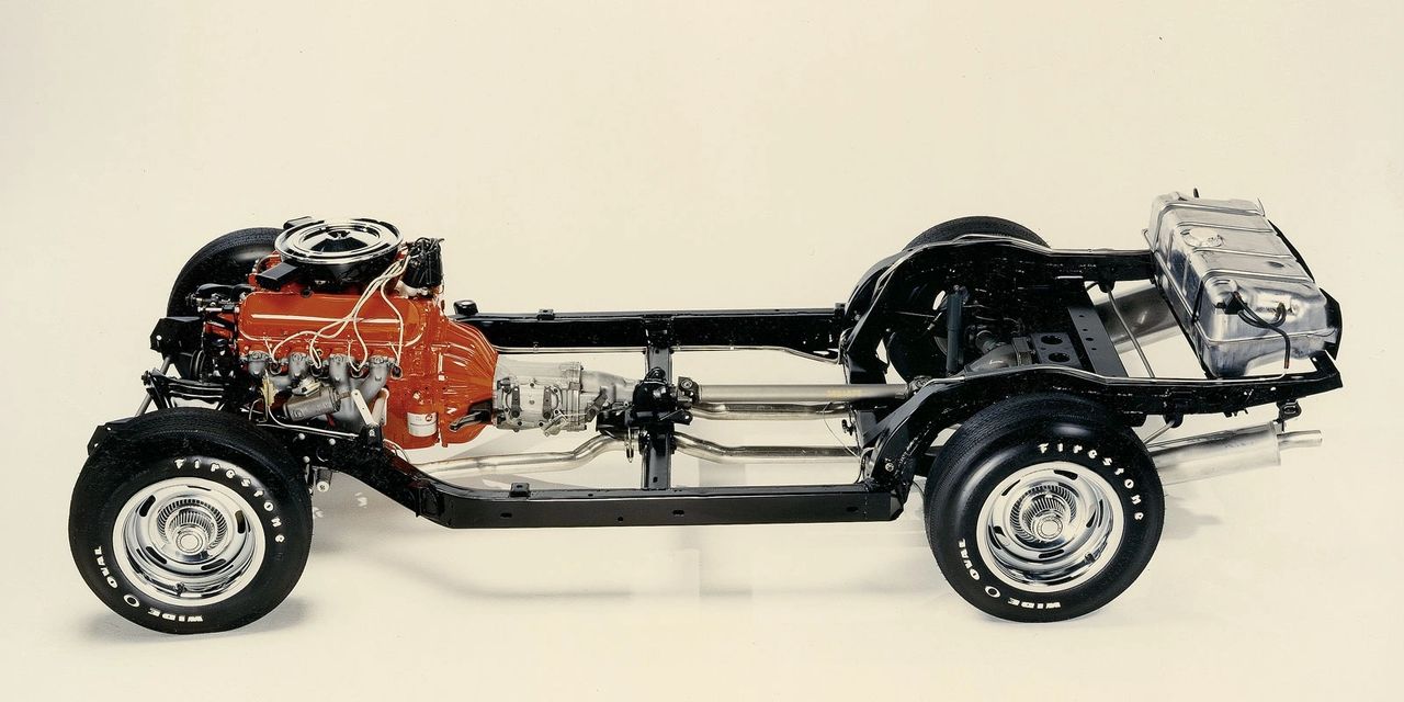 The 1968 Corvette rode on the proven C2 backbone—a stout ladder frame with the same 98-inch wheelbase, four-wheel disc brakes, and the independent rear suspension with a transverse leaf spring that had defined Sting Ray handling. Chevrolet refined, rather than replaced: rear-suspension geometry lowered the roll center and spring rates were tweaked to tame nose lift seen in early C3 development. Wider 7-inch wheels with F70-15 tires raised the grip ceiling, while the battery’s relocation behind the seats helped balance weight and free under-hood space. Steering, differential layout, and the basic brake hardware carried over, but the addition of the Turbo Hydra-Matic automatic broadened driveline choices atop that familiar, durable chassis. In short, the C3’s radical new body sat atop the Sting Ray’s best fundamentals—updated to corner harder and cruise steadier. (Image courtesy of Corvette Fever)