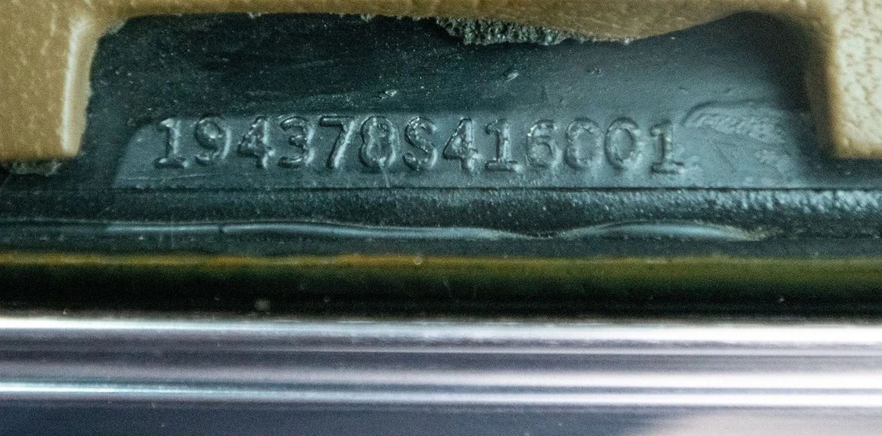 This is the VIN tag at the base of the driver-side A-pillar, visible through the windshield on 1968 Corvettes. The stamp reads 194378S416001: 1 = Chevrolet, 94 = Corvette, 37 = coupe body, 8 = 1968 model year, S = St. Louis assembly, and 416001 is the production sequence. For 1968, sequences ran from 400001–428566, placing this car mid-year. Decoding the VIN like this is essential for confirming body style, plant, and build range during authentication or restoration.