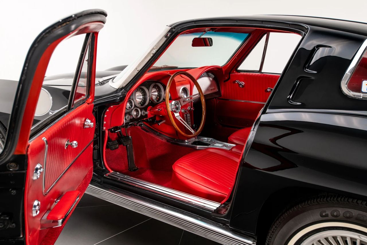 The interior of the 1963 Corvette Sting Ray was as groundbreaking as its exterior, blending race-inspired function with upscale refinement. Shown here in striking red, the cabin features contoured bucket seats, full instrumentation, and a wood-rimmed steering wheel—all laid out in a driver-focused cockpit. It was a dramatic step forward from the first-generation Corvette, offering both performance-oriented ergonomics and a touch of luxury that elevated the Sting Ray to true world-class status. (Image courtesy of RK Motors.) The interior of the 1963 Corvette Sting Ray was as groundbreaking as its exterior, blending race-inspired function with upscale refinement. Shown here in striking red, the cabin features contoured bucket seats, full instrumentation, and a wood-rimmed steering wheel—all laid out in a driver-focused cockpit. It was a dramatic step forward from the first-generation Corvette, offering both performance-oriented ergonomics and a touch of luxury that elevated the Sting Ray to true world-class status. (Image courtesy of RK Motors.)