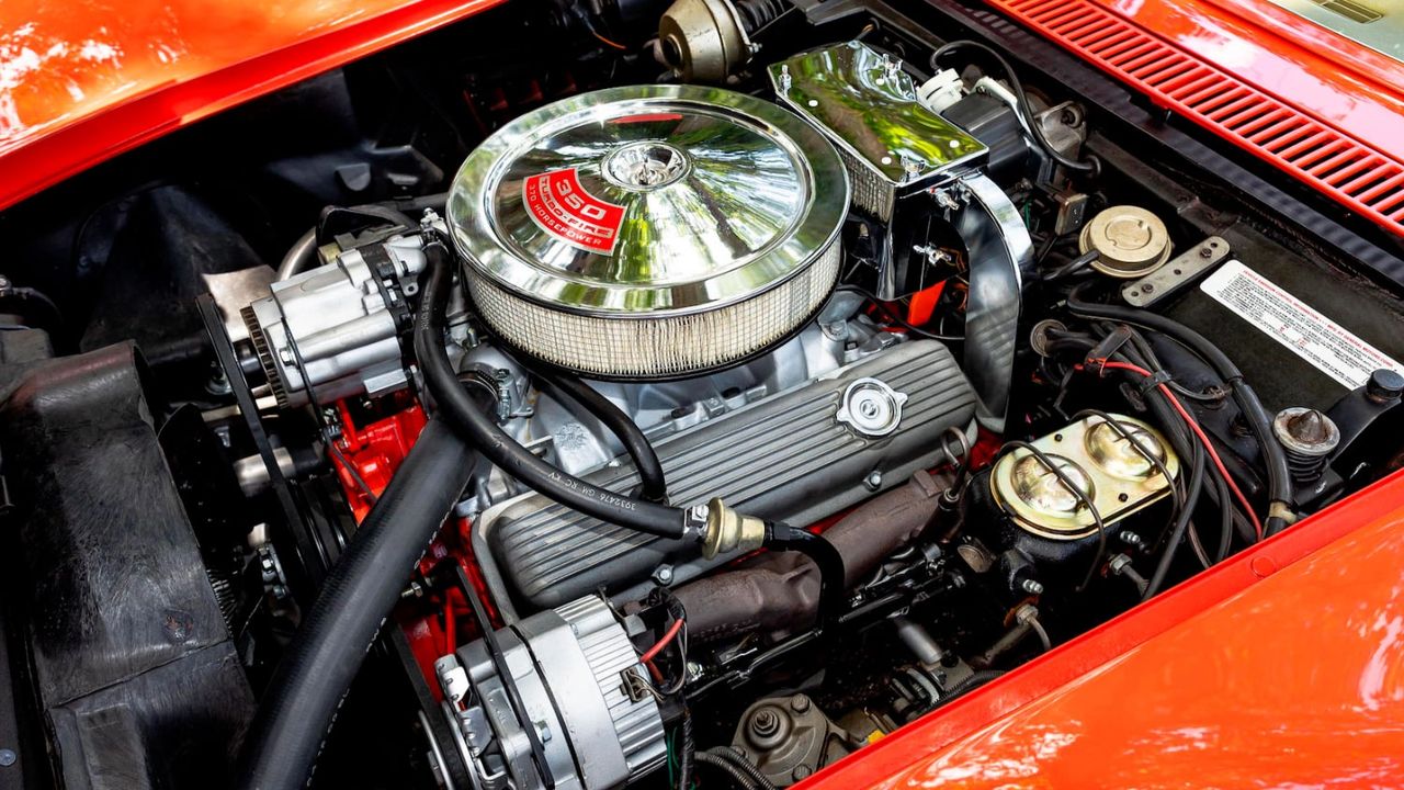 The 1970 RPO LT-1 was Chevrolet’s high-compression 350-cid small-block (4.00×3.48 in.) built like a race piece: four-bolt-main block, forged-steel crank, solid-lifter cam, high-rise aluminum intake, and a Holley 4-bbl (about 780 cfm). Factory-rated at 370 hp @ 6,000 rpm and 380 lb-ft @ 4,000 rpm, it loved to rev to a 6,500-rpm redline yet hit hard in the midrange, giving the C3 a light, urgent feel distinct from big-block cars. LT-1 Corvettes were 4-speed only in 1970 (no A/C), and wore finned aluminum valve covers and a specific domed hood—details that matched the engine’s character: crisp, responsive, and the defining heartbeat of the ’70 model year. (Image courtesy of gmauthority.com)
