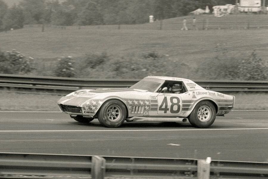 John Greenwood became one of the most recognizable privateers to turn the 1969 Corvette into a serious racing weapon. A skilled driver and tuner, Greenwood focused on extracting maximum performance from the big-block cars, reinforcing their chassis, and fitting wider tires and brakes to cope with the power. He developed distinctive aerodynamic tweaks—flared fenders, deep front air dams, and eventually towering rear spoilers—that gave his Corvettes a brutal, purposeful look while also cutting drag and improving high-speed stability. Under the hood, his builds featured heavily massaged 427- and 454-cubic-inch engines, tuned to deliver enormous horsepower while surviving the rigors of endurance racing. Greenwood’s cars were loud, aggressive, and instantly identifiable, helping to cement the Corvette’s presence on the sports car racing stage in the early 1970s. In doing so, he bridged the gap between showroom Stingrays and all-out racing prototypes, proving the Corvette could battle with the world’s best.