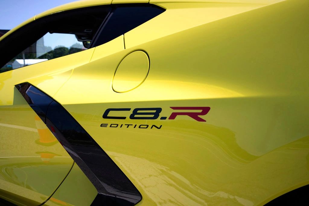 This close-up shows the “C8.R Edition” rear-quarter graphic used on the 2022 Corvette Stingray IMSA GTLM Championship Edition—the factory special-edition package created to commemorate Corvette Racing’s championship-winning C8.R program. The decal sits behind the side air intake on the rear quarter panel, linking the street car’s bodywork to the C8.R’s race-livery identity. Even without the full car in view, that C8.R Edition marking is the quick visual cue that this Stingray is the IMSA-inspired Championship Edition, not a standard production model. (Image courtesy of GM Media LLC)