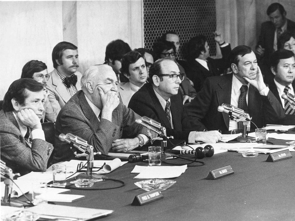 In 1973, the U.S. Senate launched one of the most consequential investigations in American political history: the Watergate hearings. For 51 days that spring and summer, senators and special counsel interrogated the machinery behind the President’s re-election campaign—unraveling a conspiracy that stretched far beyond a botched break-in at Democratic National Committee headquarters. Broadcast live to an estimated 80 million Americans, the hearings transformed accountability into prime-time national ritual, revealing secret taping systems, coded campaign slush funds, and testimony that exposed deliberate obstruction at the highest levels of government. What began as political scandal evolved into constitutional crisis, redefining public expectations of transparency and proving that even the most powerful institutions must eventually answer to the unblinking eye of record. (photo credit: Gene Forte)