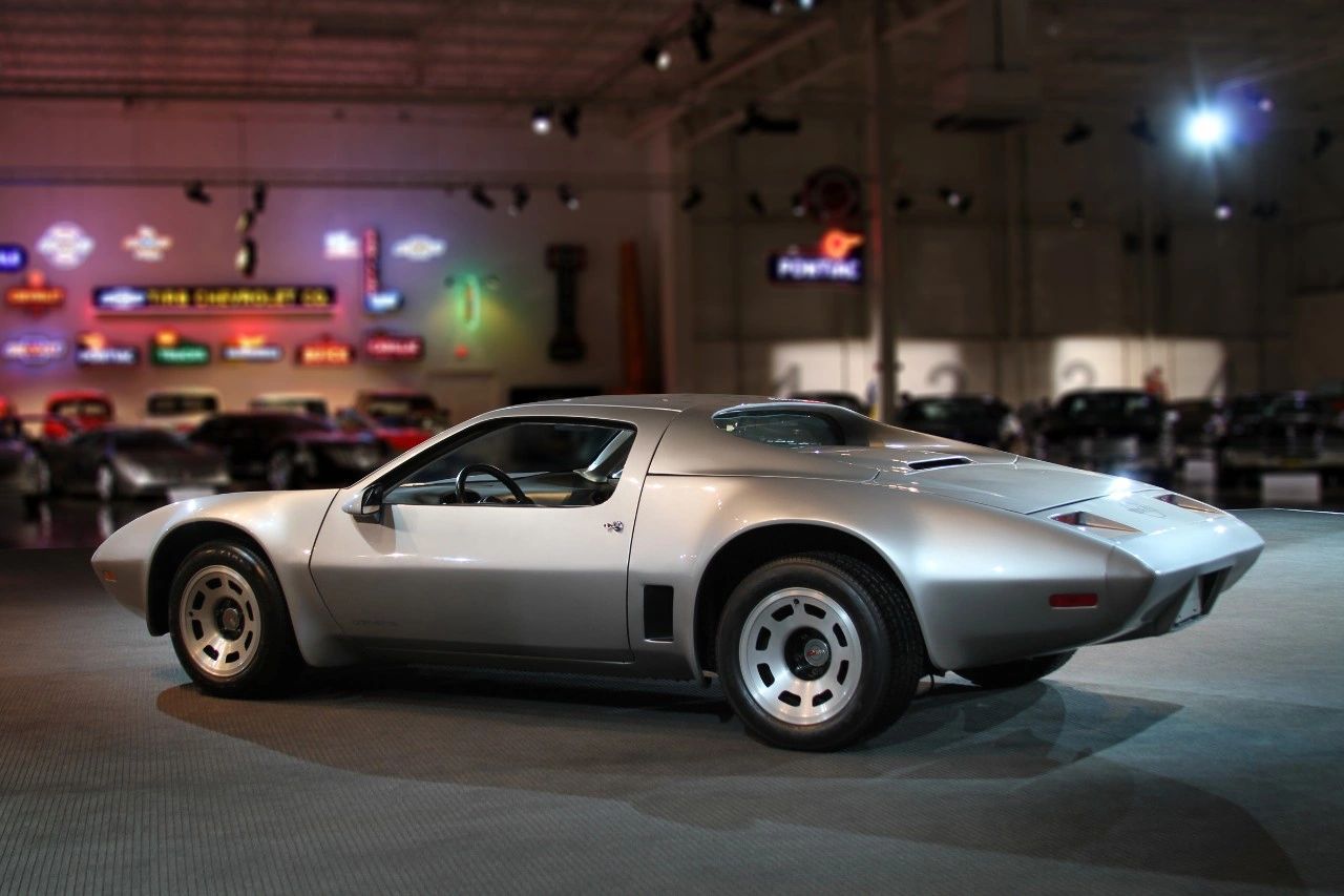 Though its internal project date is 1972, the XP-895 Reynolds Aluminum Corvette is often treated as a 1973 concept because that’s the year it made its public debut at the New York Auto Show. Developed as an evolution of the XP-882 mid-engine program, XP-895 used a transverse-mounted 400-cid small-block V-8 driving the rear wheels through a Turbo-Hydramatic and bevel gearbox. Chevrolet had two nearly identical cars built, one in conventional steel and one in aluminum, the latter crafted in partnership with Reynolds Metals to test how much weight—and therefore performance—could be gained by going all-alloy. When the silver mid-engine coupe finally rolled onto the New York show stand in 1973, it served as both a rolling laboratory for lightweight construction and a very public hint at the mid-engine Corvette future GM was actively exploring. (Image courtesy of GM Media LLC)