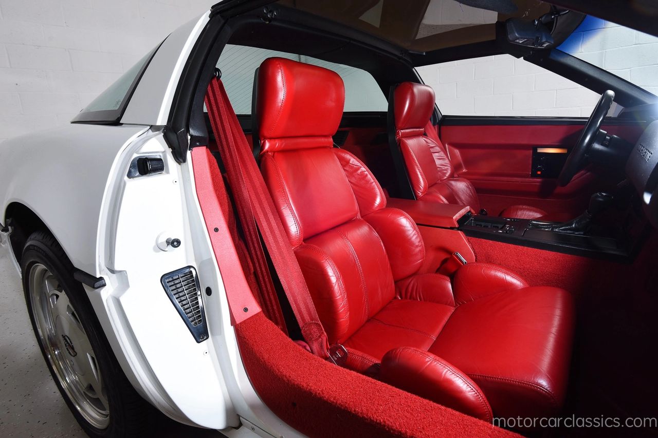 The interior of the 1989 Corvette blended high-tech function with driver-focused comfort, reflecting Chevrolet’s commitment to modern performance. The cabin featured a digital-analog hybrid instrument cluster, ergonomically designed sport seats, and a cockpit-style dash that wrapped around the driver. Premium leather upholstery, available in a range of colors, elevated the experience, while options like the Delco-Bose sound system and electronic climate control underscored the Corvette’s move toward luxury and refinement without compromising its sporting edge.