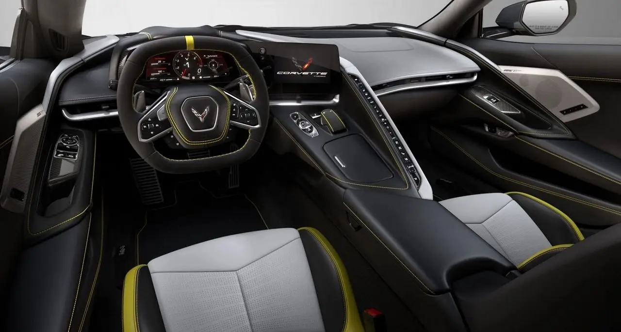 The C8’s “fighter-cockpit” cabin wrapped the driver with a squared-off wheel, a high cowl of stitched leather, and that signature ridge of climate toggles dividing the seats. In 2021 it felt even smarter: the 12-inch cluster added a clearer Track tach and richer drive-mode graphics, while wireless Apple CarPlay/Android Auto cleaned up the console. Shown here in Sky Cool Gray/Yellow Strike with Bose Performance Series grilles, it nailed the brief—driver-first ergonomics, premium materials, and just enough theater to match the car’s pace.