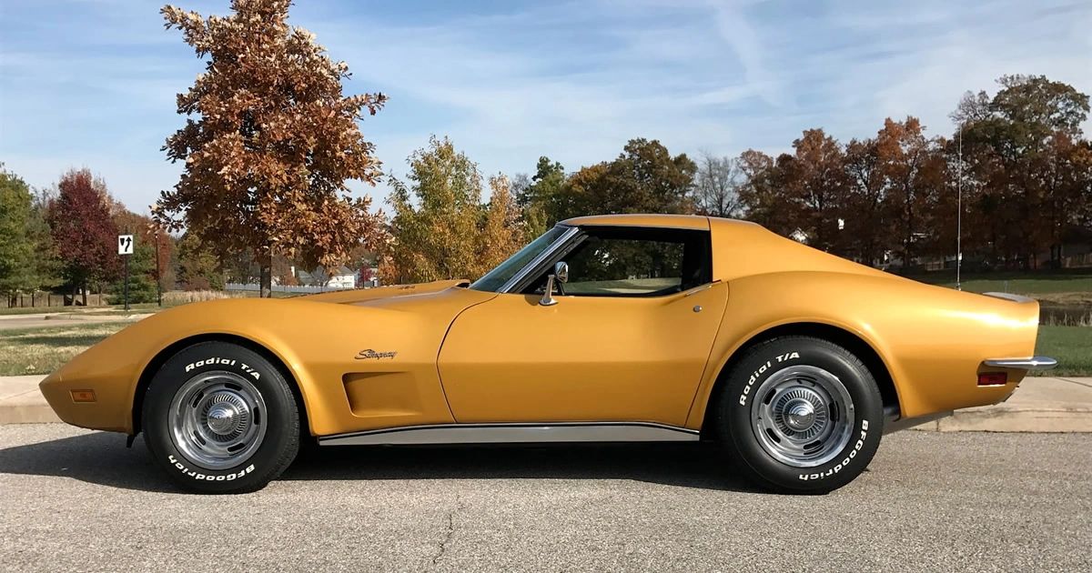In profile, this 1973 Corvette makes its point quietly: the familiar shark nose is now a body-color urethane bumper, with no trace of the gleaming chrome “bumperettes” that defined earlier C3s. It was the first Corvette to trade brightwork for impact-absorbing engineering up front, even as the traditional chrome rear bumper hung on for just one more year—literally marking 1973 as the hinge between eras. (Image courtesy Corvette Action Center)
