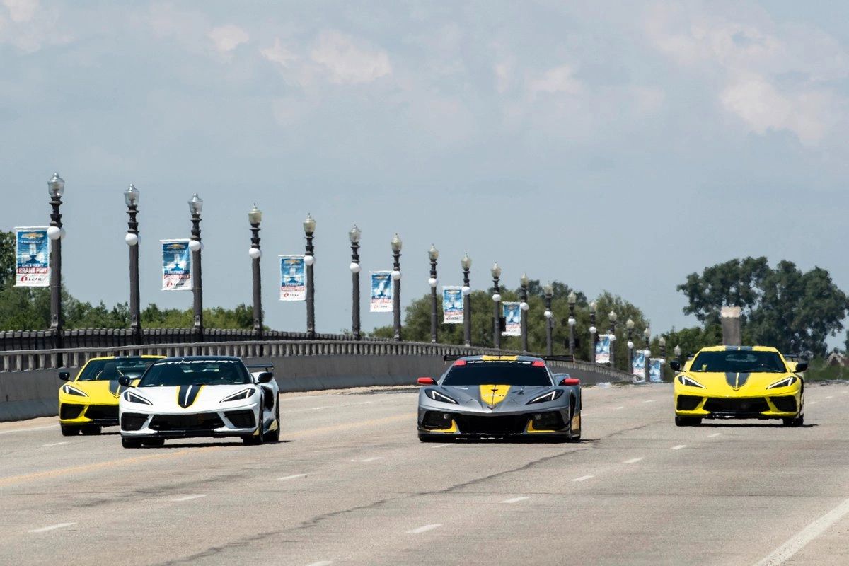 Another Richard Prince capture from Detroit’s Raceway at Belle Isle Park, this shot shows the C8 story in motion: the C8.R race car running point, flanked by the 2022 Corvette Stingray IMSA GTLM Championship Edition coupe and convertible that were styled to mirror the factory race entries. With the white Stingray Convertible pace car in the mix, the image reads like a rolling timeline—race program in the center, street-car tributes at the edges, all staged on the same circuit where Corvette Racing’s Detroit spotlight played out. It’s the kind of photo that doesn’t just document the special edition; it explains why it existed. (Image: GM/Richard Prince)