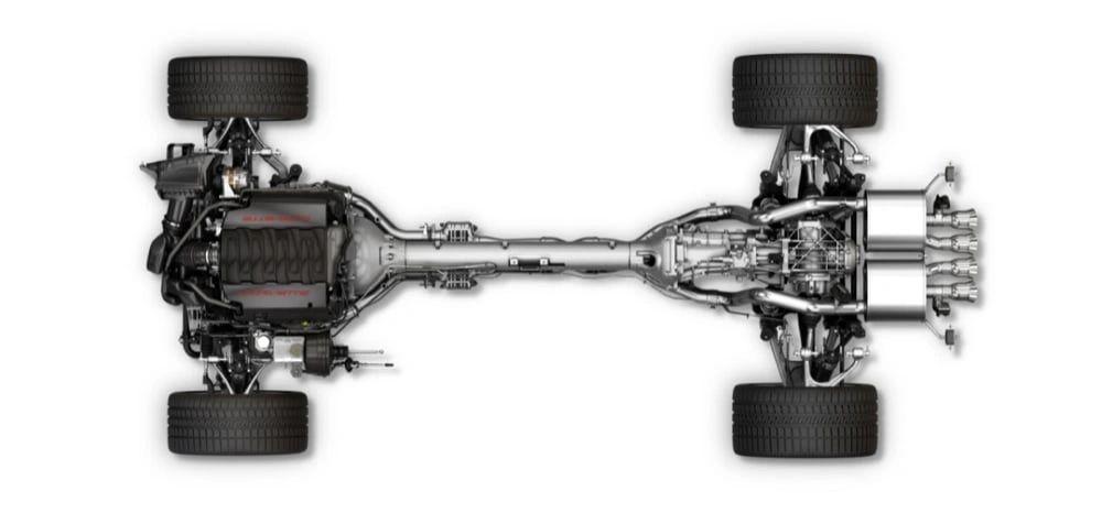 This top-down view of the 2014 Corvette Stingray reveals its front-engine, rear-transaxle layout tied together by a rigid torque tube—key to near 50/50 weight distribution. An all-aluminum structure with hydroformed rails and cast nodes slashed mass while delivering a huge jump in torsional stiffness. With the LT1 up front, the 7-speed (or auto) at the rear, and short/long-arm suspension at each corner, the C7’s hardware was engineered for crisp turn-in, traction, and high-speed stability. (Image courtesy of GM Media)