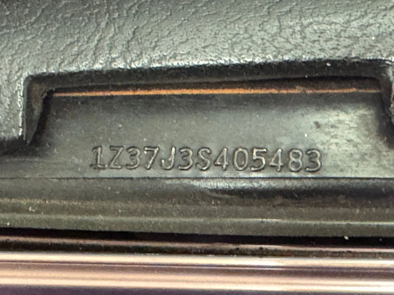 This dash VIN stamp reads 1Z37J3S405483, the unique 13-character vehicle identification number assigned to this Corvette. Decoding it shows 1 = Chevrolet, Z = Corvette, 37 = coupe body, J = L48 350-ci small-block V-8, 3 = 1973 model year, and S = St. Louis assembly plant. The final six digits (405483) mark it as the 5,483rd 1973 Corvette built, an important reference point for confirming its numbers-matching status. (source: Classic Auto Mall)