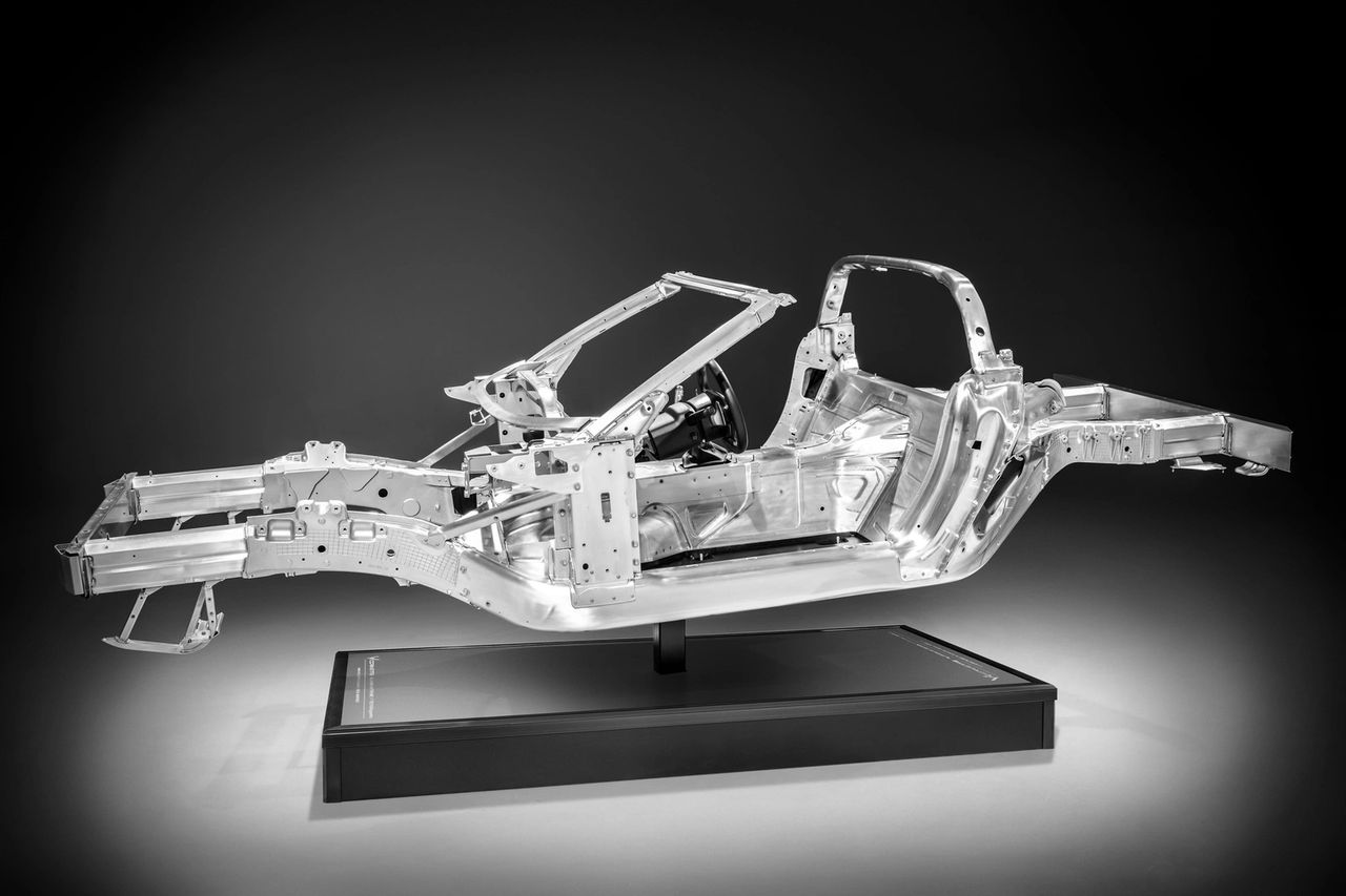 The C7’s all-aluminum backbone—built in-house at Bowling Green—was the game-changer. Cast nodes, tailored extrusions, stampings, and a beefy center tunnel created clean load paths, making the structure about 100 lb lighter and over 50% stiffer than the old steel frame. That headroom let the suspension, NVH tuning, and even the convertible top behave like premium hardware rather than compromises. (Image courtesy of GM Media LLC)
