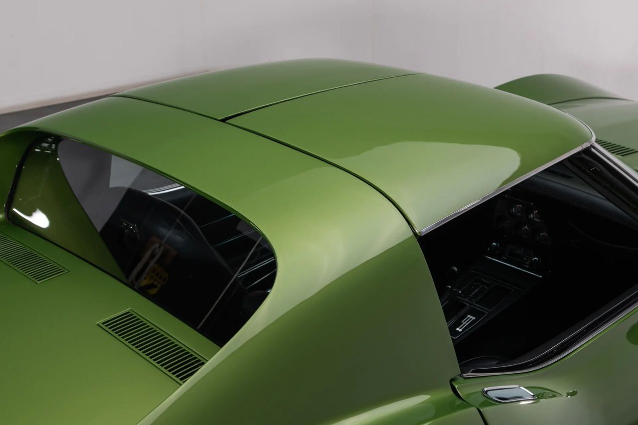 For the 1973 Corvette, fixing the rear glass delivered a real NVH win, even if the headlines were chasing bumpers and horsepower drama. Making the window permanent reduced wind turbulence and pressure pulses in the cabin, cutting the booming buffet that came with the old removable glass. With one solid, sealed light, Chevrolet also eliminated rattle points and air gaps, helping keep highway noise out instead of letting it echo in. The result was a cockpit that felt tighter, quieter, and less tiring at speed, without taking anything away from the character of the car. It was a small engineering decision that made a surprisingly big difference the longer you drove. (source: RK Motors)
