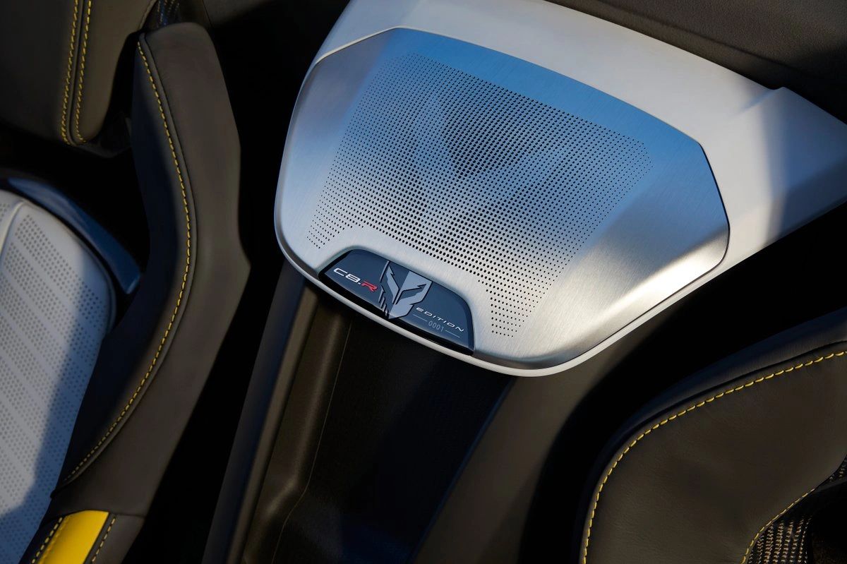This interior close-up shows one of the Championship Edition’s most distinctive “you’re sitting in something special” details: the C8.R Edition numbered plaque with the Jake emblem, integrated into the cabin trim. Surrounding it is the edition’s Strike Yellow and Sky Cool Gray interior theme, accented by yellow contrast stitching that echoes the race-car-inspired exterior graphics. It’s a subtle but intentional reminder that this isn’t a standard Stingray interior—it’s a commemorative spec tied directly to the C8.R program. (Image courtesy of GM Media LLC)