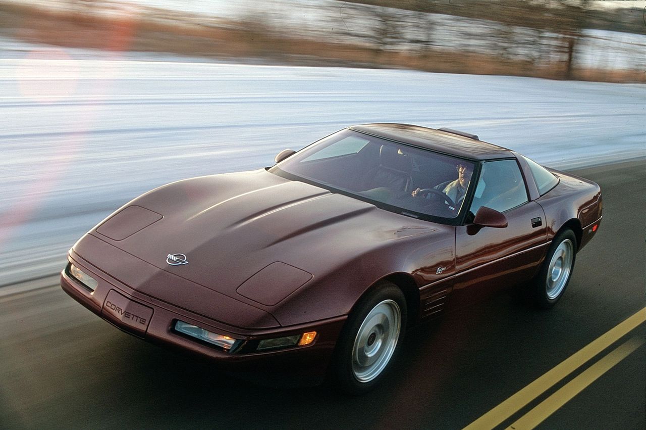 The 1993 Corvette ZR-1, pictured here in striking Ruby Red Metallic, represented the pinnacle of C4 performance. Beneath its wide rear haunches lurked the Lotus-engineered, Mercury Marine–built LT5 V8, producing 405 horsepower and delivering blistering acceleration with a soundtrack all its own. With subtle exterior cues like the unique rear fascia and ZR-1 badging, the “King of the Hill” stood apart from the standard Corvette while retaining its timeless shape. On the open road—whether carving through snow-dusted landscapes or stretching its legs on the highway—the ZR-1 embodied Chevrolet’s vision of a world-class supercar that could rival Europe’s finest. (Image courtesy of Car & Driver magazine)