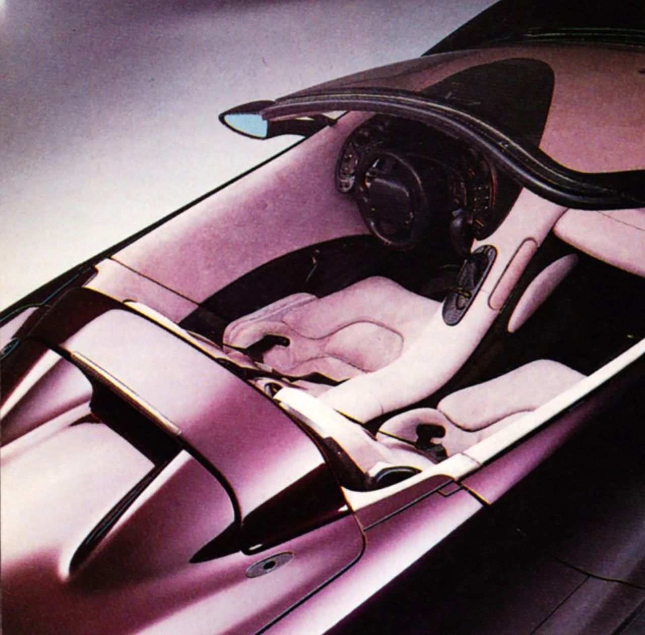 From above, the Stingray III’s cabin shows off its futuristic dual-cockpit layout, a sculpted interior that cradled driver and passenger in deep, form-fitting seats. The flowing center spine bisected the space with dramatic intent, reinforcing the Corvette’s identity as a sports car built around the individual behind the wheel. This perspective also highlights how the exterior bodywork and interior design were conceived as one continuous form—an approach that gave the concept a level of integration rarely seen in production cars of its era.