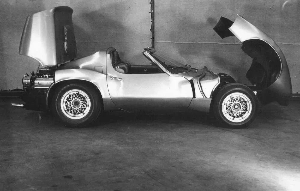 With the XP-819 opened up like a cutaway model, you can see how its body was essentially three major components: a front clip, a central cockpit tub, and a rear engine section. Both the nose and tail hinged away from the center structure, giving engineers excellent access to the suspension, steering, cooling hardware, and the transversely mounted V8 out back. This modular layout was pure experimental thinking—more race car than production Corvette—and it allowed rapid changes to mechanicals and aero surfaces as the program evolved. It’s a vivid reminder that XP-819 was as much a rolling testbed as it was a styling exercise. (Image courtesy of GM Media LLC) With the XP-819 opened up like a cutaway model, you can see how its body was essentially three major components: a front clip, a central cockpit tub, and a rear engine section. Both the nose and tail hinged away from the center structure, giving engineers excellent access to the suspension, steering, cooling hardware, and the transversely mounted V8 out back. This modular layout was pure experimental thinking—more race car than production Corvette—and it allowed rapid changes to mechanicals and aero surfaces as the program evolved. It’s a vivid reminder that XP-819 was as much a rolling testbed as it was a styling exercise. (Image courtesy of GM Media LLC)