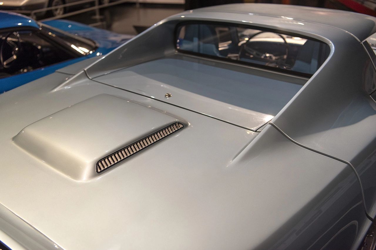 At the rear, the XP-819’s deck panel is deceptively simple but packed with purpose. The subtle raised blister and finely ribbed vent hint at the transverse V8 buried underneath, drawing hot air out of the engine bay without disrupting the car’s smooth aero profile. The crisp panel break just ahead of the backlight marks the hinge line for the entire rear body section, which tilts up for service like a race car. It’s a clean, almost understated solution that masks just how radical the mechanical layout really was. (Image courtesy of Joe Kolecki/Kolecki Photography) At the rear, the XP-819’s deck panel is deceptively simple but packed with purpose. The subtle raised blister and finely ribbed vent hint at the transverse V8 buried underneath, drawing hot air out of the engine bay without disrupting the car’s smooth aero profile. The crisp panel break just ahead of the backlight marks the hinge line for the entire rear body section, which tilts up for service like a race car. It’s a clean, almost understated solution that masks just how radical the mechanical layout really was. (Image courtesy of Joe Kolecki/Kolecki Photography)