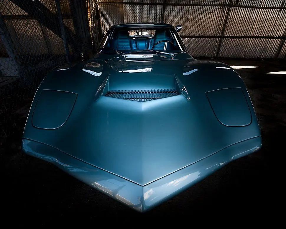 From this angle, it’s hard to believe you’re looking at a Corvette prototype from 1964 and not a modern concept car. The XP-819’s razor-edged nose, deep-set hood duct, and wide, muscular stance still feel absolutely current—proof that Shinoda and his team were sketching decades ahead of their time. (Photo credit: Stan Dzugan) From this angle, it’s hard to believe you’re looking at a Corvette prototype from 1964 and not a modern concept car. The XP-819’s razor-edged nose, deep-set hood duct, and wide, muscular stance still feel absolutely current—proof that Shinoda and his team were sketching decades ahead of their time. (Photo credit: Stan Dzugan)