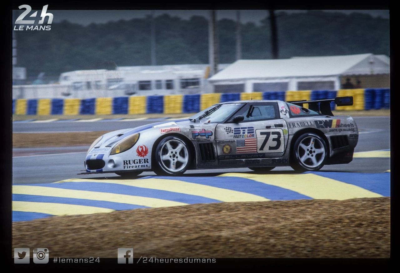 Rain-polished curbs, yellow lights, and blue-collar thunder. Callaway’s #73 SuperNatural Corvette skims the Le Mans chicanes like a power tool on wet glass—front-engine torque tucked under a battered, stickered shell, rear wing carving spray into ribbons. The five-spokes blur, side vents inhale, and that long C4 hood points down the Mulsanne with purpose. Driven by Bertaggia/Unser/Jelinski, this was the GT2 grinder that climbed all night through traffic and weather, proving that an American V-8 with good hands and better discipline could dance in European rain—and finish on the GT2 podium for keeps.