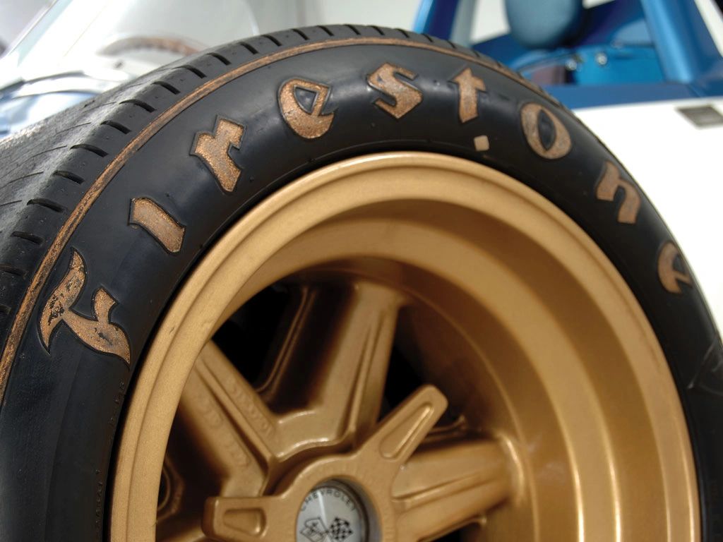 Gold Halibrand magnesium, knock-off spinner, and Firestone rubber—CERV I’s rolling lab in a single frame. Zora used wheels like these to rapid-fire tire tests at Continental Divide Raceway, proving that grip and predictability start at the contact patch, not with “band-aid” rubber. The lighter mag wheel and inboard-brake setup cut unsprung mass so the suspension—and the tire—could do their best work. (Image courtesy of Motor Trend)
