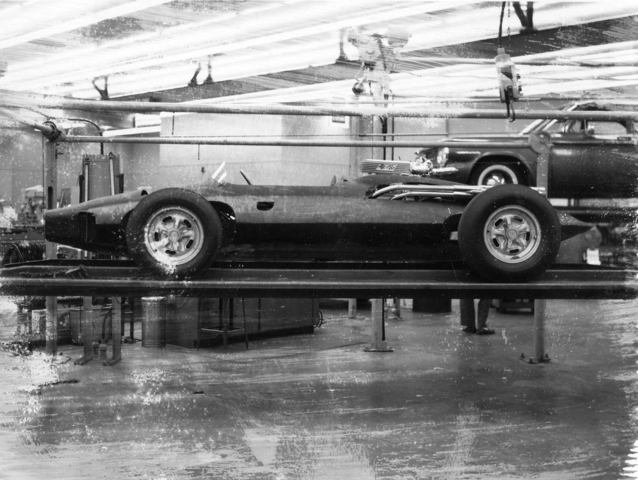 In Bill Mitchell’s studio, Larry Shinoda and Tony Lapine “skinned” Duntov’s spaceframe the way racers did—tight, thin, and only where structure demanded it. Working off the jig, they pulled a lightweight fiberglass shell over the hard points, carving a low cowl, tiny aero screen, faired headrest, and a clipped tail that bled drag without adding mass. Panels were kept simple and removable so engineering could reach the suspension, plumbing, and mid-mounted small-block between runs. Every scoop and cutout followed function—cooling, clearance, serviceability—so the CERV I’s body became what it needed to be: a fast, clean wrapper for testing ideas at speed. (Image courtesy of GM Media LLC)