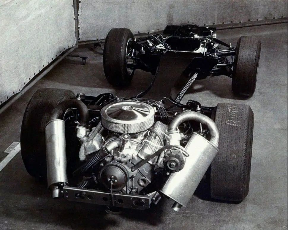 Laid bare, the XP-819’s hardware shows just how radical Frank Winchell’s team was willing to get in the mid-1960s. The car rode on a welded sheet-steel backbone chassis that tied the front and rear suspension together and carried a “birdcage” passenger cell, with every major chassis, steering, and suspension component engineered specifically for this one-off. Hanging entirely behind the rear axle was a reverse-rotation, cast-iron 327-cid GM marine V-8, bolted backward to a modified two-speed Pontiac Tempest automatic transaxle—an arrangement that put roughly 69 percent of the XP-819’s 2,600–2,700 pounds on the rear wheels. Fully independent suspension with unequal-length upper and lower wishbones, coil springs with concentric shocks at each corner, and anti-roll bars (thin at the tail, much stouter up front) tried to tame that extreme rear weight bias. The result was a chassis that was sophisticated, experimental, and unforgiving all at once—an engineering laboratory on wheels that proved just how tricky a true rear-engine Corvette would be. (Image courtesy of GM Media LLC) Laid bare, the XP-819’s hardware shows just how radical Frank Winchell’s team was willing to get in the mid-1960s. The car rode on a welded sheet-steel backbone chassis that tied the front and rear suspension together and carried a “birdcage” passenger cell, with every major chassis, steering, and suspension component engineered specifically for this one-off. Hanging entirely behind the rear axle was a reverse-rotation, cast-iron 327-cid GM marine V-8, bolted backward to a modified two-speed Pontiac Tempest automatic transaxle—an arrangement that put roughly 69 percent of the XP-819’s 2,600–2,700 pounds on the rear wheels. Fully independent suspension with unequal-length upper and lower wishbones, coil springs with concentric shocks at each corner, and anti-roll bars (thin at the tail, much stouter up front) tried to tame that extreme rear weight bias. The result was a chassis that was sophisticated, experimental, and unforgiving all at once—an engineering laboratory on wheels that proved just how tricky a true rear-engine Corvette would be. (Image courtesy of GM Media LLC)