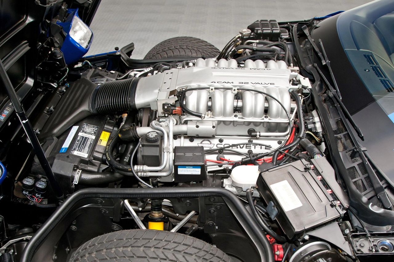 Pictured is the ZR-1’s 5.7-liter LT5—Lotus-designed and Mercury Marine-built—a quad-cam, 32-valve aluminum V8 rated at 405 hp and 385 lb-ft for 1994. The wide “4 CAM 32 VALVE” plenum and long, paired intake runners feed the LT5’s two-stage porting, and its unique electronics/cooling set it apart from the pushrod LT1. A true “King of the Hill” powerplant, it gave the C4 a high-revving, exotic character. (Image courtesy of RK Motors)