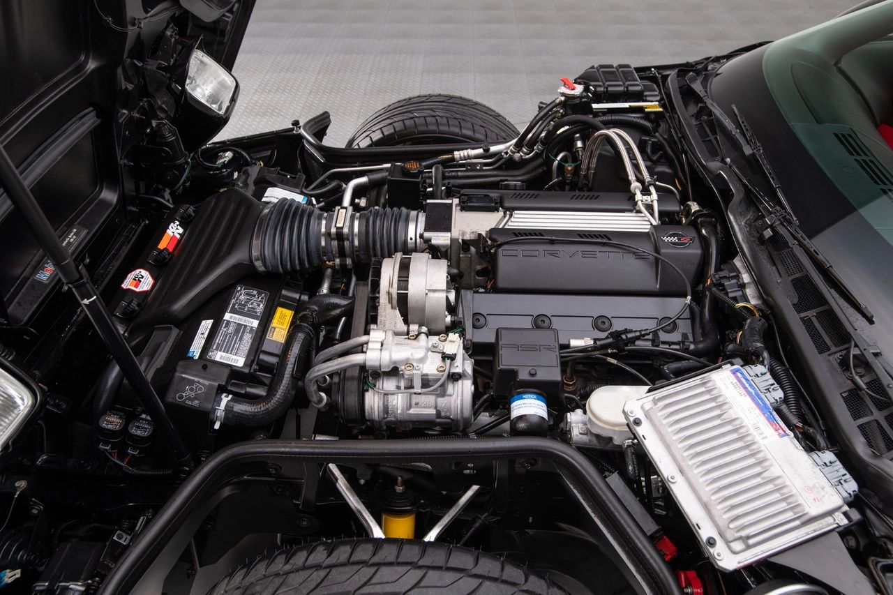 The 1994 Corvette’s 5.7-liter LT1—featuring reverse-flow cooling and Opti-Spark ignition—delivered a crisp 300 hp and 340 lb-ft. This tidy bay shows the compact accessory drive, under-hood PCM, and that signature “CORVETTE” intake plenum. (Image courtesy of RK Motors)