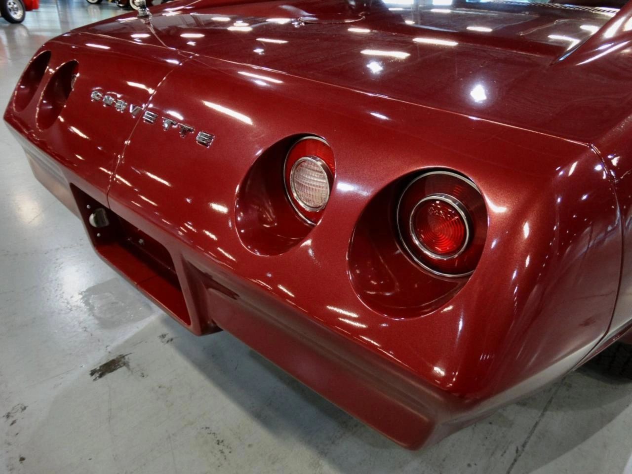 The 1974 Corvette’s split rear bumper is on full display here, its body-color urethane halves framing the tail and visually echoing the car’s signature four round taillights. Just above, the smoothed gas filler door stands out with its lack of emblem, giving the rear deck a cleaner, almost custom look that lets the sculpted lines and rich paint take center stage. (Image courtesy of Facebook user John Berg)