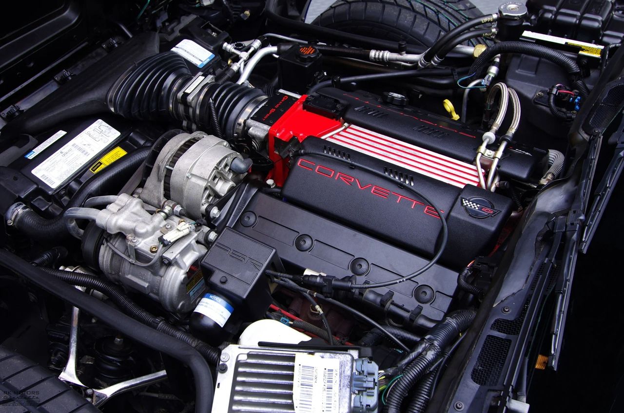 1996 LT4: the 330-hp Gen II small-block with aluminum heads, 1.6:1 rockers, and 10.8:1 squeeze—the red intake and wires are the tell. Manual-only, 6,300-rpm redline; the C4’s finished thought under the hood. (Image courtesy of RK Motors)