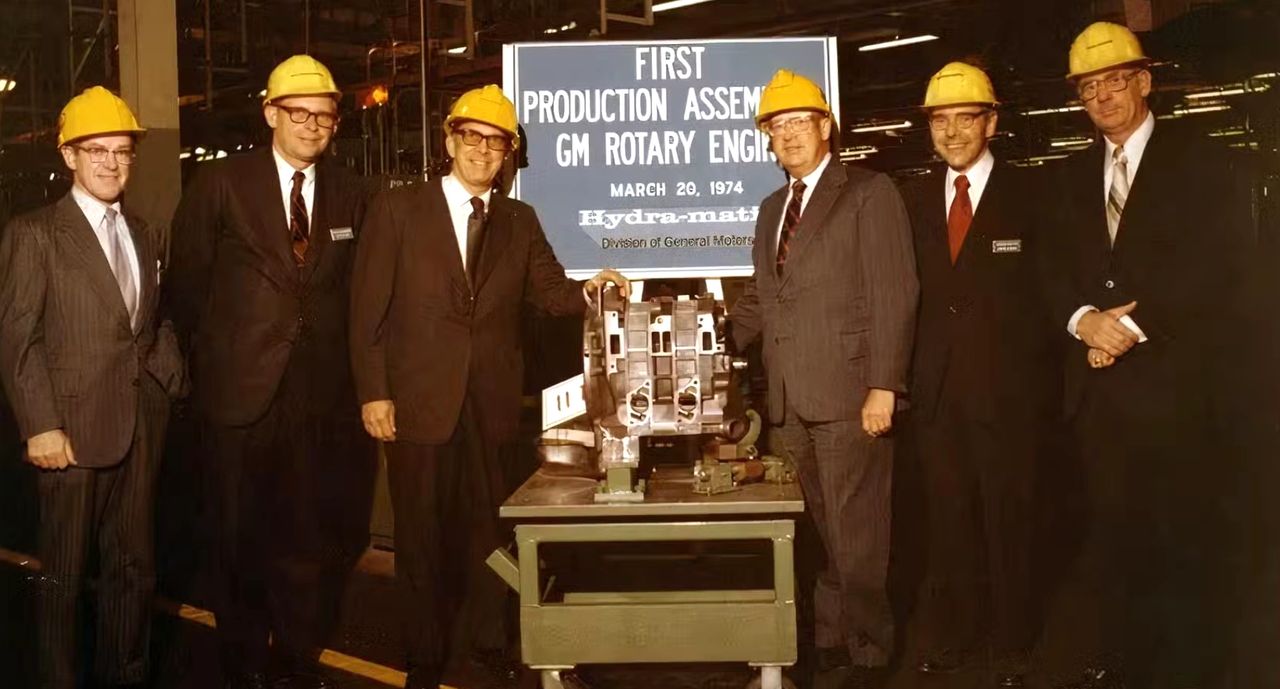This archival image captures a proud moment in GM history: the ceremonial launch of the “First Production Assembly GM Rotary Engine” at Hydra-Matic on March 20, 1974. That date marked the official start of GM’s ambitious Wankel program, which aimed to put a smooth, high-revving rotary engine into production. The plan was to use this powerplant in the Chevrolet Vega (and later the Monza 2+2), bringing rotary technology to mainstream buyers. At the same time, GM envisioned a more exotic role for the engine in the XP-987 GT “Two-Rotor Corvette,” showcasing its performance potential in a mid-engine sports car. Unfortunately, changing emissions standards, fuel economy concerns, and the fallout from the 1973 oil crisis ultimately killed the program before any rotary-powered Chevrolets reached showrooms. As a result, this photo stands as both a celebration of bold innovation and a reminder of one of GM’s most fascinating “what might have been” stories. (Image courtesy of GM Media LLC) This archival image captures a proud moment in GM history: the ceremonial launch of the “First Production Assembly GM Rotary Engine” at Hydra-Matic on March 20, 1974. That date marked the official start of GM’s ambitious Wankel program, which aimed to put a smooth, high-revving rotary engine into production. The plan was to use this powerplant in the Chevrolet Vega (and later the Monza 2+2), bringing rotary technology to mainstream buyers. At the same time, GM envisioned a more exotic role for the engine in the XP-987 GT “Two-Rotor Corvette,” showcasing its performance potential in a mid-engine sports car. Unfortunately, changing emissions standards, fuel economy concerns, and the fallout from the 1973 oil crisis ultimately killed the program before any rotary-powered Chevrolets reached showrooms. As a result, this photo stands as both a celebration of bold innovation and a reminder of one of GM’s most fascinating “what might have been” stories. (Image courtesy of GM Media LLC)