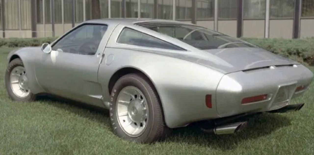 Finished in the understated silver it wore when Pininfarina shipped it back to Detroit as the “Chevrolet GT,” this early form of the Corvette Two-Rotor looks more like an Italian show car than an American experiment. The clean metallic finish accentuates its glassy rear hatch and crisp shoulder line, highlighting just how refined the design was before it ever received Corvette badging or bright red paint. (Image courtesy of GM Media LLC) Finished in the understated silver it wore when Pininfarina shipped it back to Detroit as the “Chevrolet GT,” this early form of the Corvette Two-Rotor looks more like an Italian show car than an American experiment. The clean metallic finish accentuates its glassy rear hatch and crisp shoulder line, highlighting just how refined the design was before it ever received Corvette badging or bright red paint. (Image courtesy of GM Media LLC)
