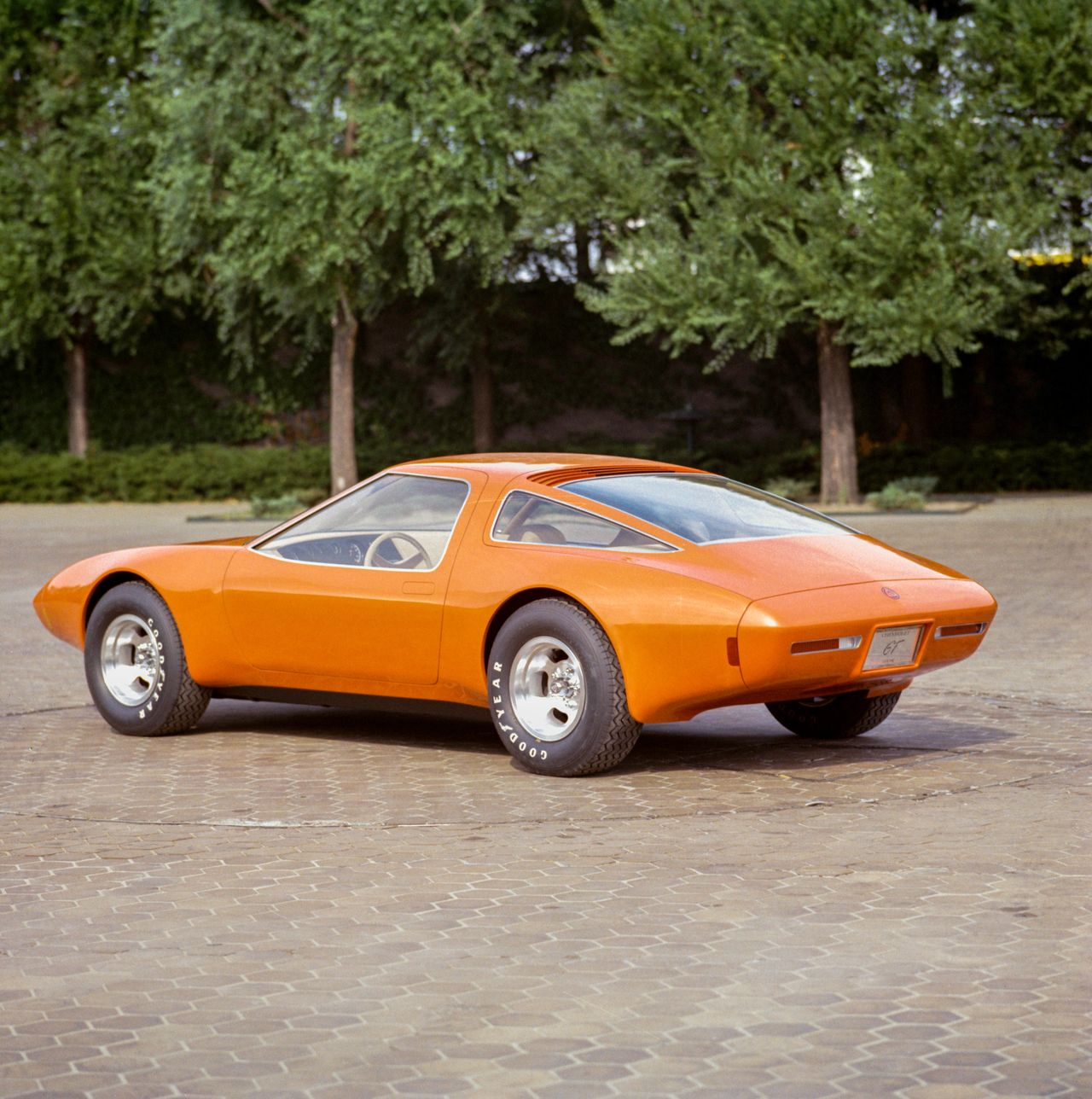 The 1971 XP-987 GT styling buck was far more than a static design exercise—it was the first moment GM’s leadership could walk around, study, and feel what a mid-engine Corvette might truly be. Built full-size and finished in vivid orange, the buck allowed designers and engineers to evaluate sightlines, proportions, aerodynamics, and packaging long before committing to a running prototype. Its presence in the courtyard and studio made the concept tangible, helping teams refine everything from cabin ergonomics to airflow management over the rear deck. Just as importantly, the buck became a powerful persuasion tool inside GM, convincing executives that this radical rotary-powered Corvette deserved to leap from clay and fiberglass into a fully operational show car. In many ways, the XP-987 GT’s entire journey began the moment this styling buck proved the vision was not only feasible—but irresistible. (Image courtesy of GM Media LLC) The 1971 XP-987 GT styling buck was far more than a static design exercise—it was the first moment GM’s leadership could walk around, study, and feel what a mid-engine Corvette might truly be. Built full-size and finished in vivid orange, the buck allowed designers and engineers to evaluate sightlines, proportions, aerodynamics, and packaging long before committing to a running prototype. Its presence in the courtyard and studio made the concept tangible, helping teams refine everything from cabin ergonomics to airflow management over the rear deck. Just as importantly, the buck became a powerful persuasion tool inside GM, convincing executives that this radical rotary-powered Corvette deserved to leap from clay and fiberglass into a fully operational show car. In many ways, the XP-987 GT’s entire journey began the moment this styling buck proved the vision was not only feasible—but irresistible. (Image courtesy of GM Media LLC)