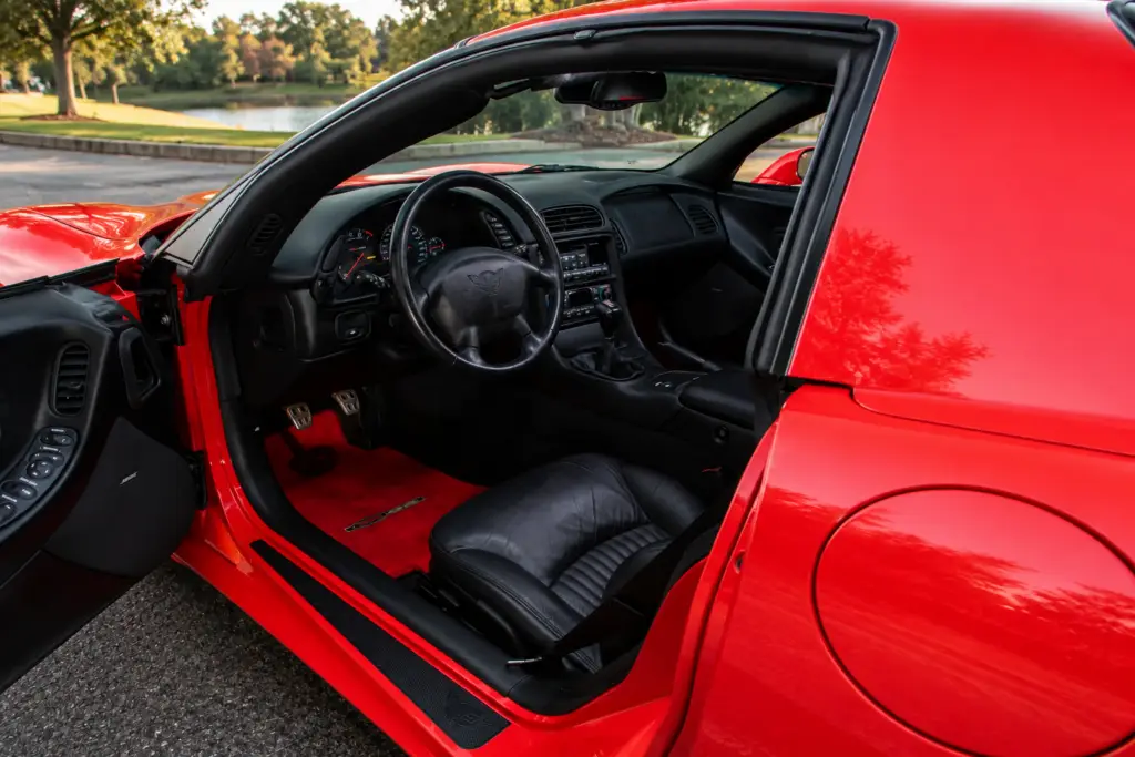 Weight reduction influenced nearly every aspect of the 2001 Z06, beginning with the fixed-roof body visible here. Derived from the earlier C5 hardtop, the configuration eliminated the removable roof panel and large rear hatch of the standard coupe, replacing them with a permanently enclosed roof structure, thinner rear glass, and a conventional trunk opening. The result provided Chevrolet with a lighter, more rigid foundation before engineers removed additional mass through thinner glass, lighter wheels and tires, a compact battery, and the titanium exhaust system. Rather than reducing weight at the expense of refinement or structural integrity, the fixed-roof design allowed the Z06 to become both lighter and more responsive under demanding driving conditions.