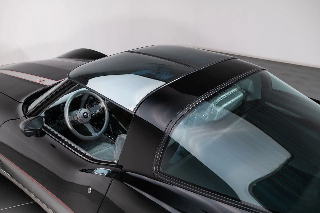 For 1978, Corvette’s profile changed with that big wrap-around rear glass—a fastback backlight that instantly modernized the C3, improved rearward visibility, and cleaned up airflow off the tail. It also created a broader luggage shelf for T-top bags and weekend gear, even if you still loaded it from the cabin because the glass didn’t open. The piece was a manufacturing flex for the era, a compound-curved panel that became a signature look and paired neatly with the year’s interior refresh—and on the Pace Car, bolt-on spoilers. The convenience of a true opening hatch wouldn’t arrive until the 1982 Collector Edition, but the statement began here. (Image courtesy of RK Motors) For 1978, Corvette’s profile changed with that big wrap-around rear glass—a fastback backlight that instantly modernized the C3, improved rearward visibility, and cleaned up airflow off the tail. It also created a broader luggage shelf for T-top bags and weekend gear, even if you still loaded it from the cabin because the glass didn’t open. The piece was a manufacturing flex for the era, a compound-curved panel that became a signature look and paired neatly with the year’s interior refresh—and on the Pace Car, bolt-on spoilers. The convenience of a true opening hatch wouldn’t arrive until the 1982 Collector Edition, but the statement began here. (Image courtesy of RK Motors)
