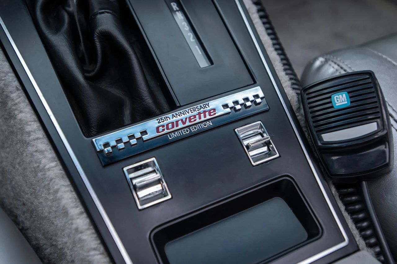 ChatGPT said: Centered on the shifter, the polished “25th Anniversary • Corvette • Limited Edition” console badge turns every start-up into a ceremony, its checker motif quietly saluting Indy. Flanking chrome-tipped power-window toggles and satin-black trim give the cockpit a tidy, upscale finish, while the period-correct GM CB mic at the ready is pure 1978 theater. Together, these details capture the Pace Car brief in miniature—celebratory, fully loaded, and unmistakably of its moment. (Image courtesy of RK Motors) ChatGPT said: Centered on the shifter, the polished “25th Anniversary • Corvette • Limited Edition” console badge turns every start-up into a ceremony, its checker motif quietly saluting Indy. Flanking chrome-tipped power-window toggles and satin-black trim give the cockpit a tidy, upscale finish, while the period-correct GM CB mic at the ready is pure 1978 theater. Together, these details capture the Pace Car brief in miniature—celebratory, fully loaded, and unmistakably of its moment. (Image courtesy of RK Motors)