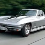 Silver Pearl 1967 Chevrolet Corvette Sting Ray 427 coupe, the final C2 Corvette built, driving on the road.