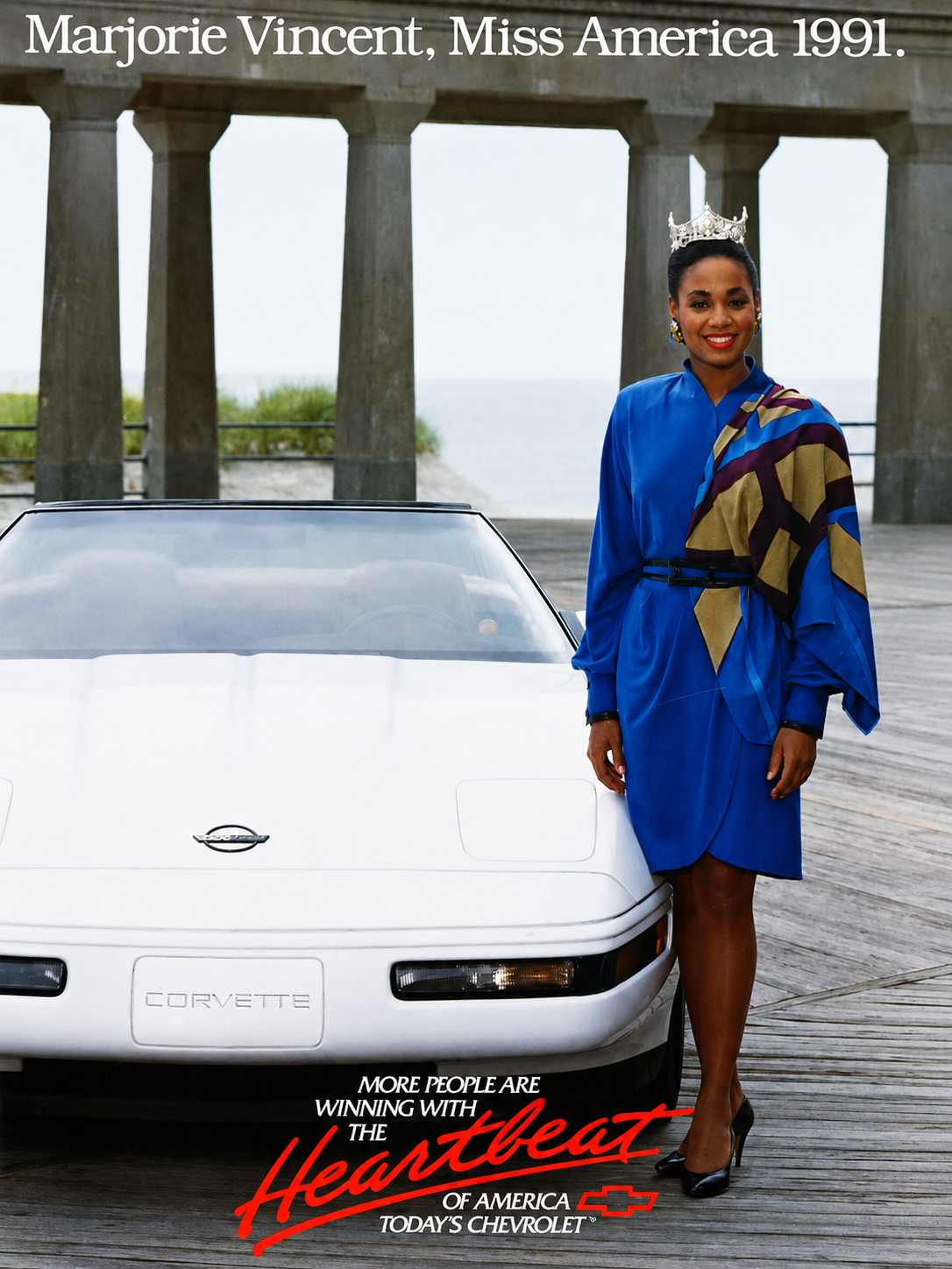 Miss America 1991 Marjorie Vincent of Illinois poses beside a white 1991 Chevrolet Corvette on a boardwalk in a Chevrolet “Heartbeat of America” promotional photograph.