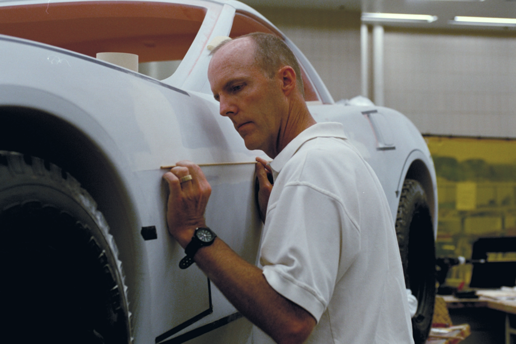 Tom Peters works on a clay model of the C6 Corvette.