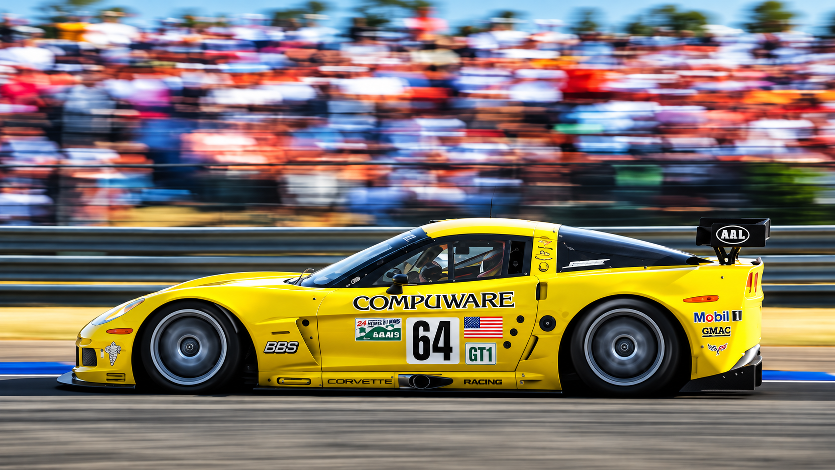 Yellow No. 64 Chevrolet Corvette C6.R GT1 race car speeds around the Circuit de la Sarthe during the 2006 24 Hours of Le Mans, with blurred spectators in the background. The Corvette Racing entry, driven by Oliver Gavin, Olivier Beretta, and Jan Magnussen, captured the GT1 class victory and finished fourth overall.